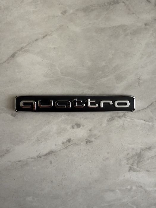 Значок quattro Audi
