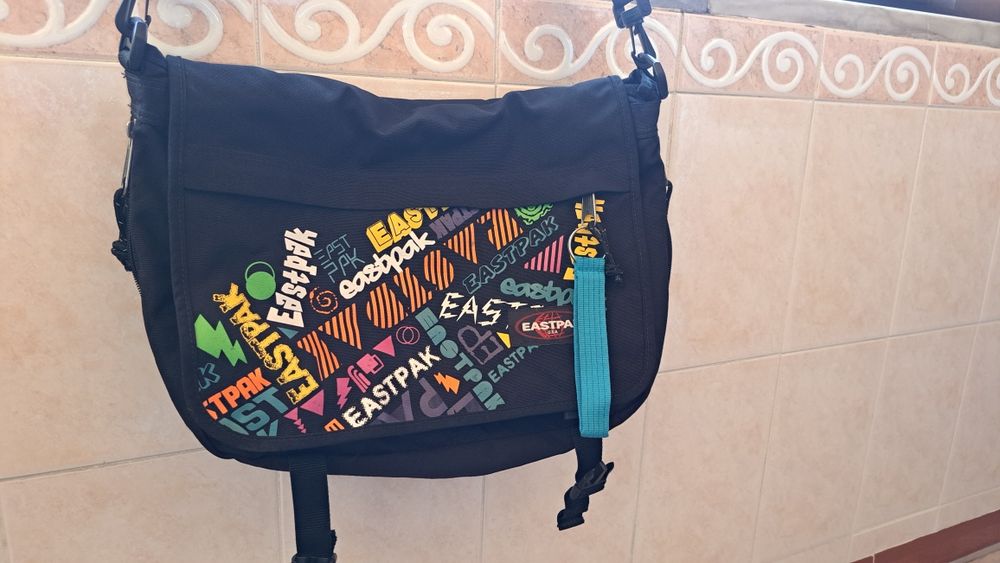 Eastpak multicolor crossbody bag with multiple interior pockets.