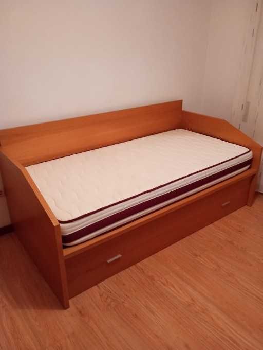 Cama dupla com colchões.