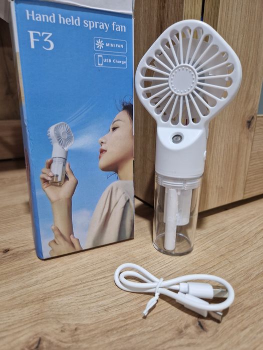 Portable handheld fan with reservoir for adding fresh water.64584842316931120