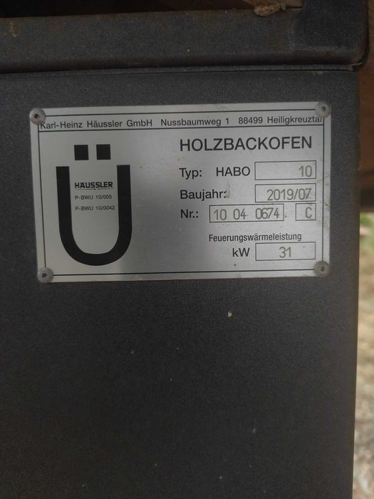 Forno de pedra a lenha profissional e móvel, montado sobre um chassis de reboque, concebido para eventos e utilização comercial em pequena escala.