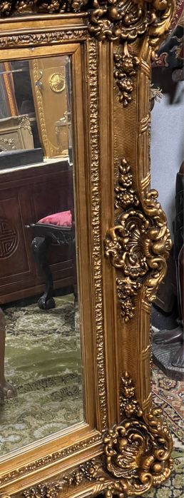 Grandioso espelho biselado em talha dourada