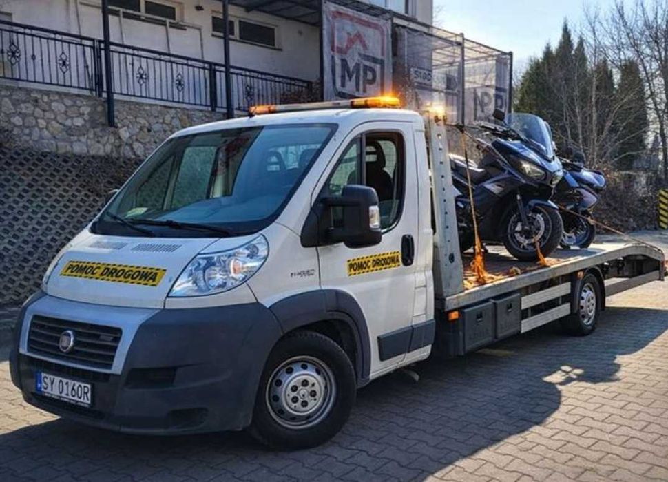 Pomoc drogowa transport pojazdów maszyn towarów auto laweta przyczepa
