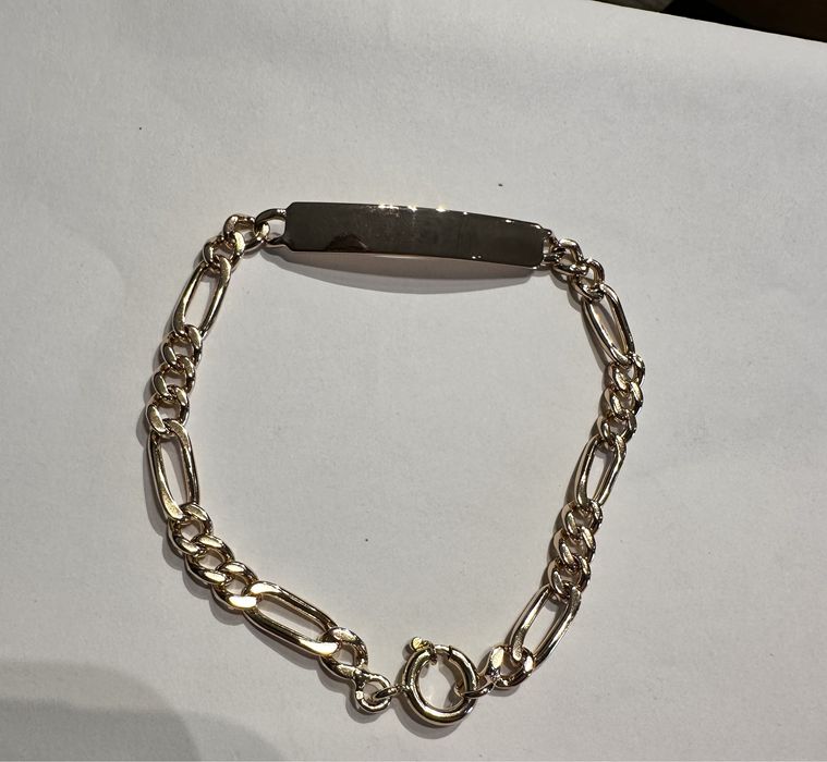 Pulseira em ouro macisso com chapa. 19,2 quilates