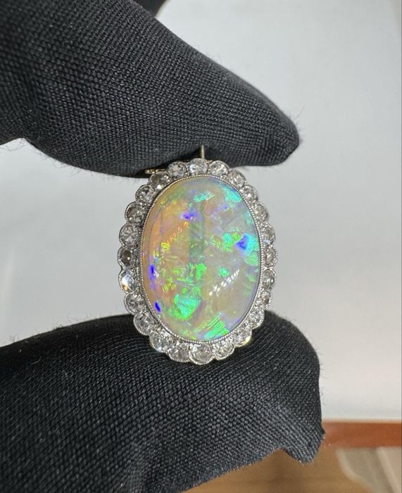 Золота брошка з натуральним оплом та натуральними діамантами.