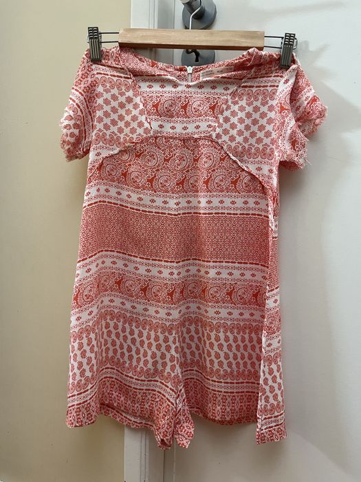 Macacão de criança laranja e branco da Zara