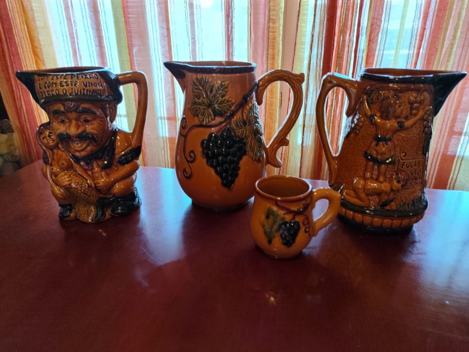 Conjunto de três canecas de vinho e um copo, com motivos tradicionais portugueses