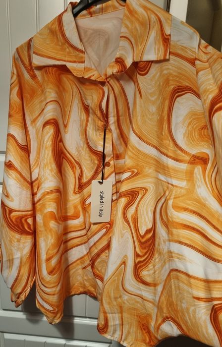 Camisa em tons laranja, tecido acetinado, mangas morcego. Oversized