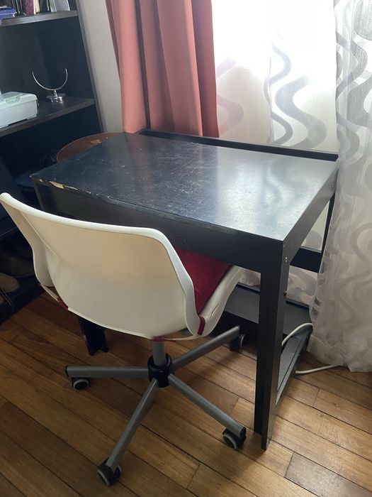 Mesa preta de madeira e cadeira branca giratória