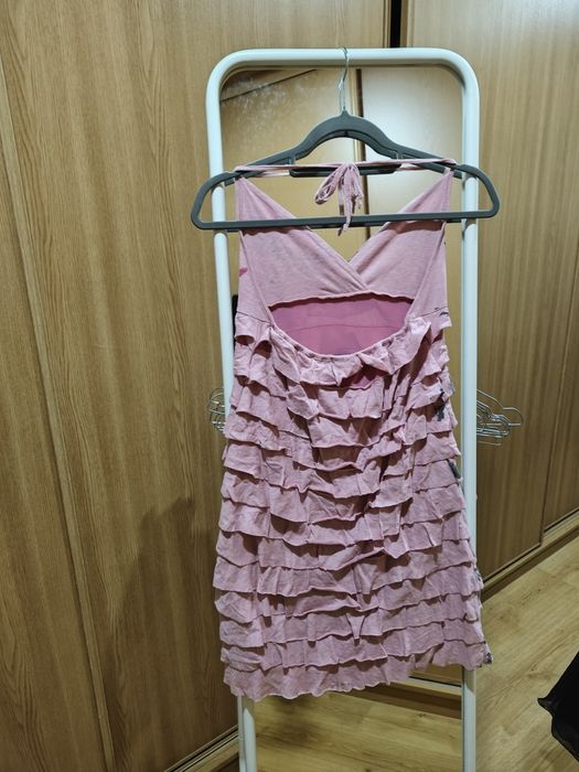 Vestido curto, com folhos cor de rosa.