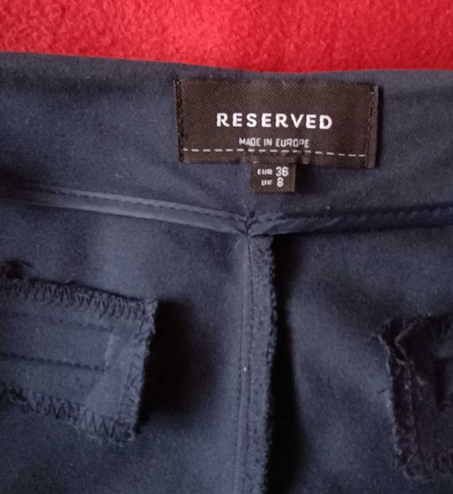 Eleganckie spodnie granatowe z rozciętą nogawką dołem Reserved