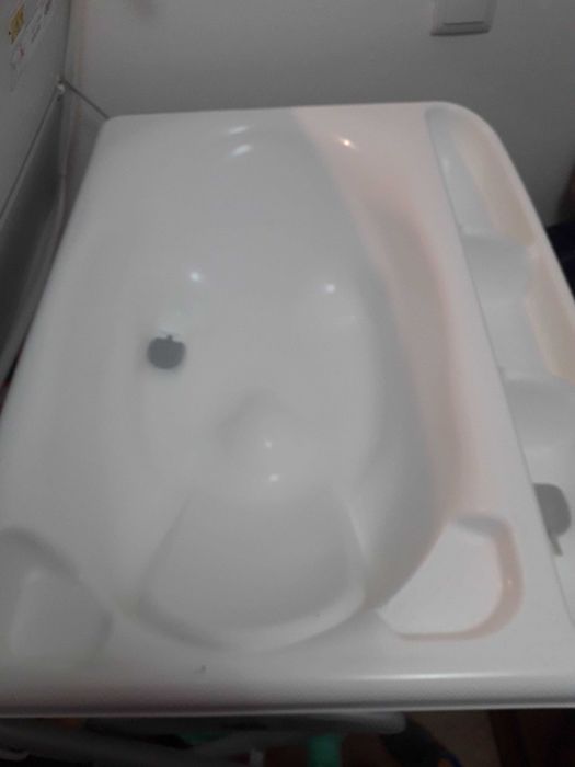 Fraldário com banheira e arrumação.