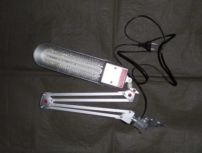 Лампа люминесцентная серебристая. На струбцине и на подставке.