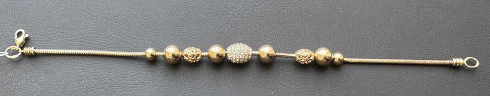 Золотий браслет оздоблений камінням