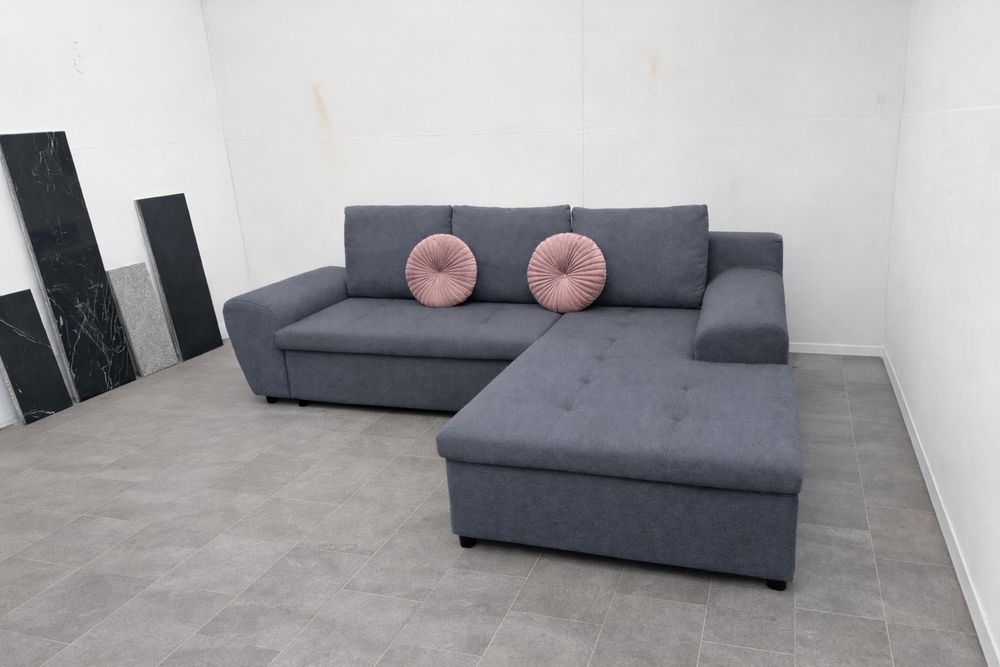 Szary narożnik rozkładany z funkcją spania używany transport