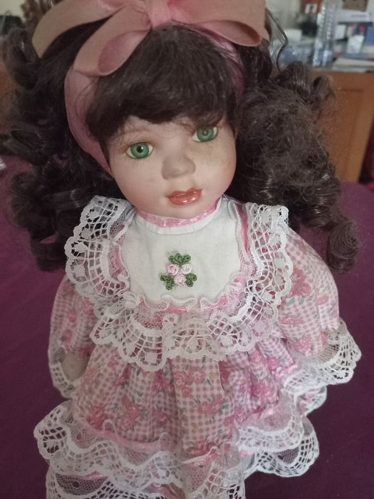 Linda boneca com o rosto em porcelana