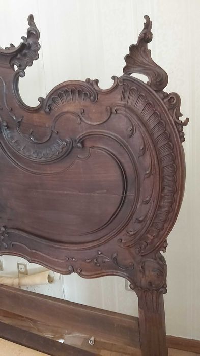 Cama casal com cabecera e estructura de madeira maciça e esculpida.