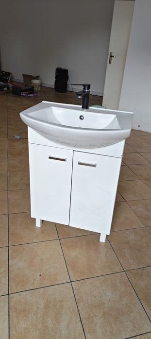 Szafka łazienkowa z umywalką i baterią.