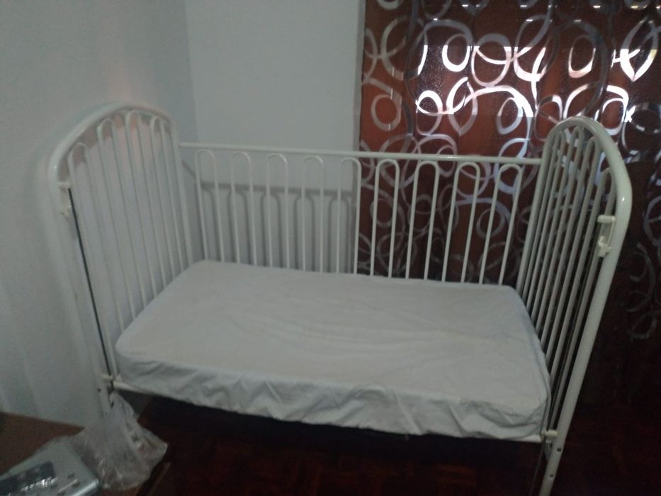 White iron bed with bars