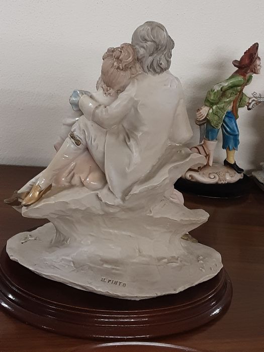 Estatueta  em marfinite marcada  25 cm altura x 22,5 cmx 18,5 cm diâm