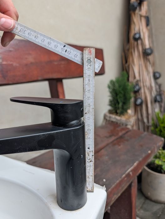 Umywalka z czarną baterią i syfonem