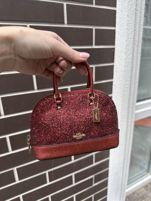Ефектна міні-сумочка Coach, оригінал.Червоний колір із сяючим глітером, золота фурнітура та фірмовий брелок. Ідеальний яскравий акцент!
