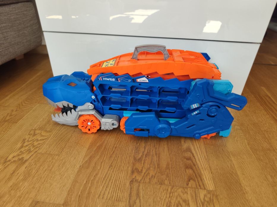 HOT WHEELS T-REX MEGA Trandporter dinozaur 2w1 Tory Wyścigowe  + autka