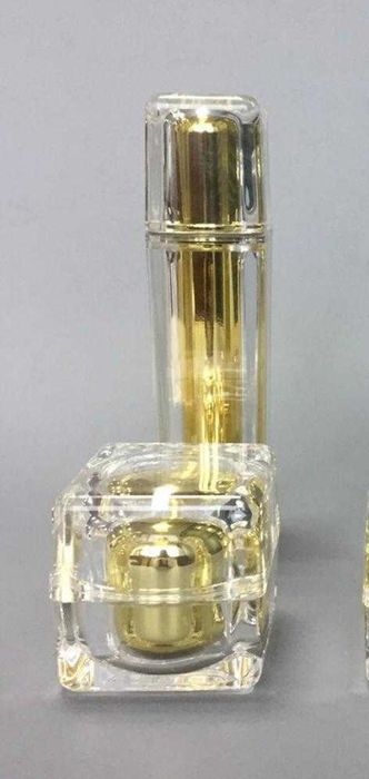 Frasco para loção cosmética e boião de creme em acrílico dourado