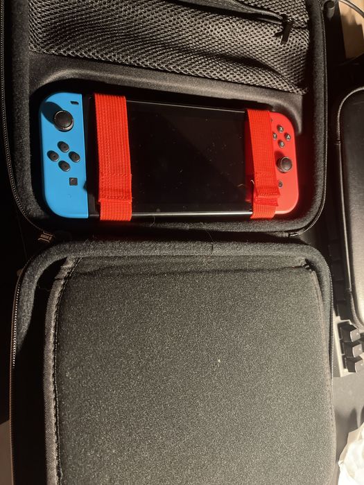 Nintendo Switch, games, charger, bag, and carrying case64284554711555122