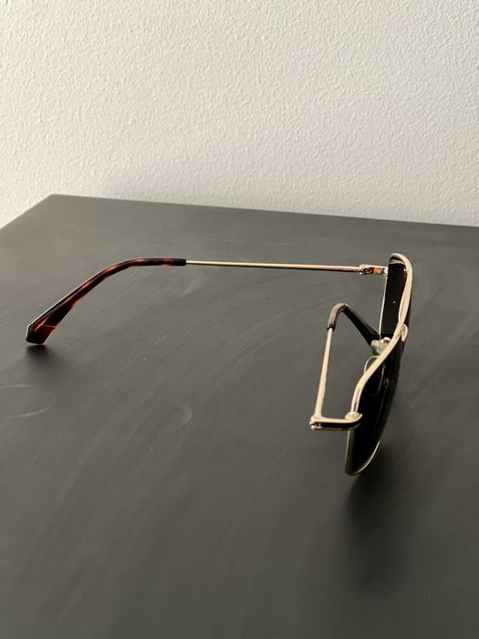 Oculos de sol dourados Polaroid