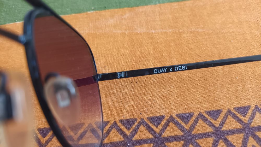 Óculos de sol marca QUAY AUSTRALIA com lentes com cor desbotada na bas