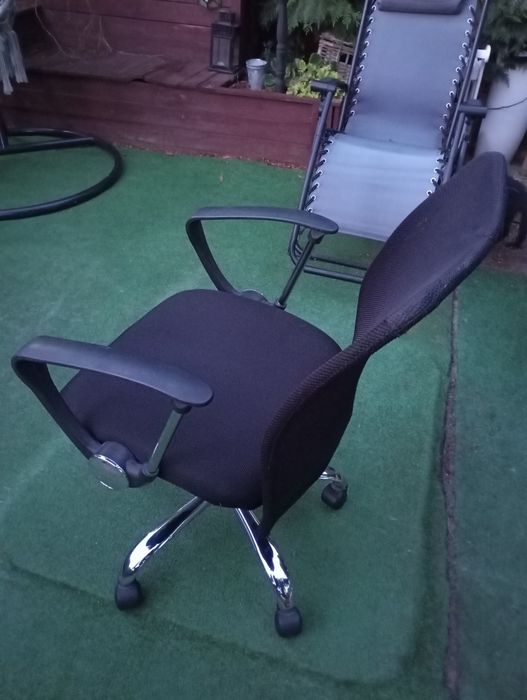 Czarny fotel obrotowy, krzesło biurowe na kółkach. Regulowana wysokość