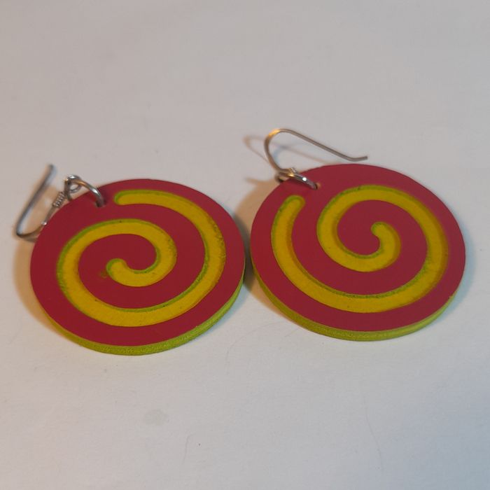 Wooden earrings in the shape of spirals.