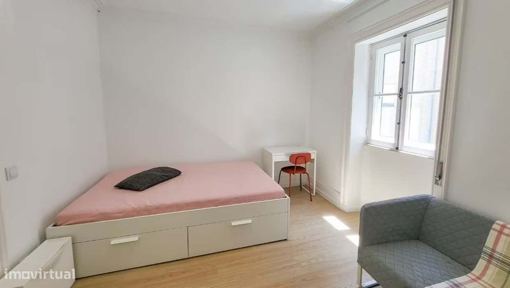 Superior room with shared bathroom and a sofa