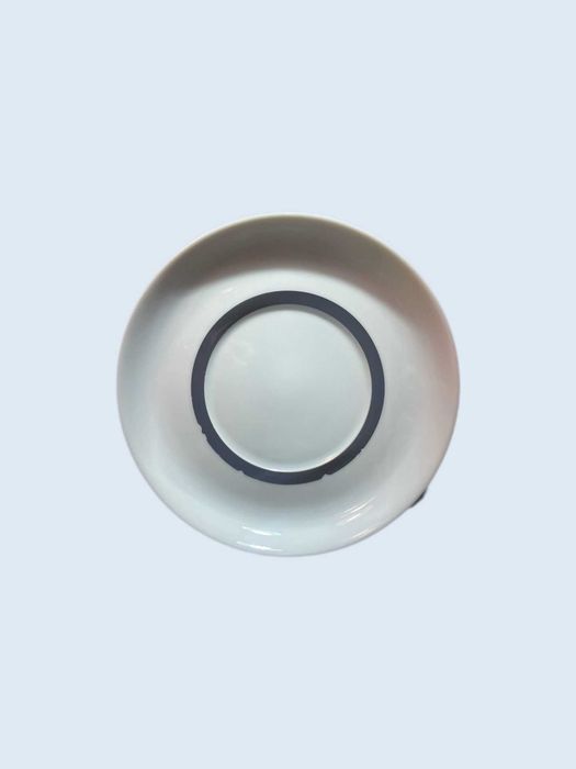 White porcelain saucers by Spal with dark blue band