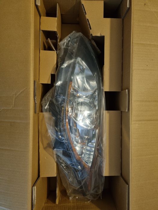 Reflektor lampa Mazda 3, 08- nowy, oryginalny, lewy.
