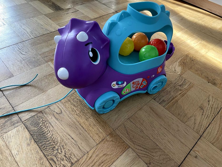 Іграшка каталка Fisher price динозавр веселий трицератопс