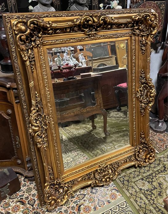 Grandioso espelho biselado em talha dourada
