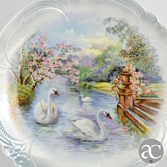Par de pratos porcelana Europeia, decorados com lago, flores e cisnes