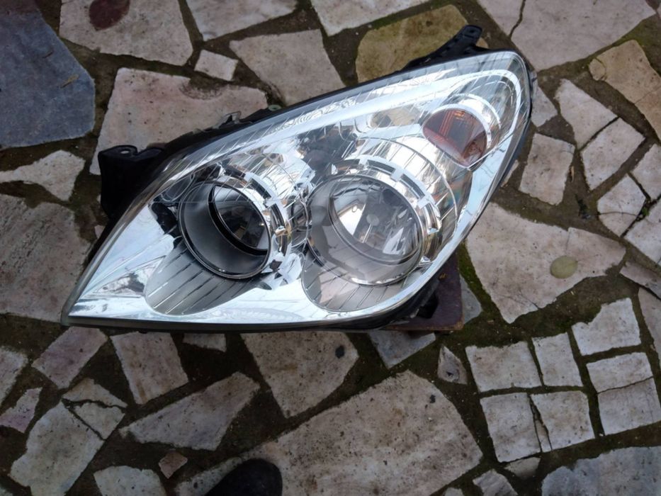 Farol frontal esquerdo Opel Astra