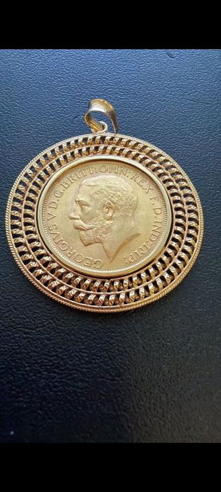 Medalha libra em ouro de 22kt com aro de 19,2kt