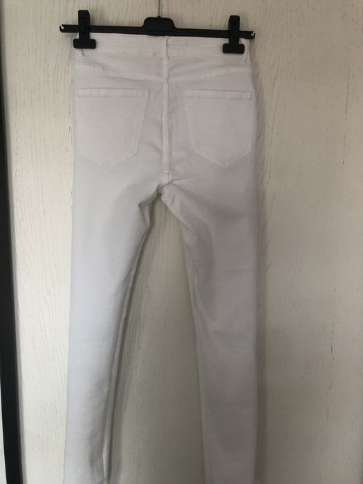 Białe spodnie z przetarciami jeans zara