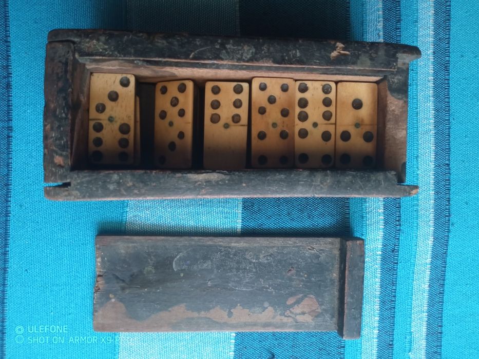 Dominó de osso e ebano e metal