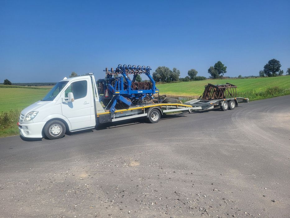 Transport maszyn , pomoc drogowa , auto holowanie , autolaweta .