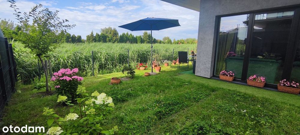 Nowe mieszkanie z garażem, komórką  i ogródkiem.