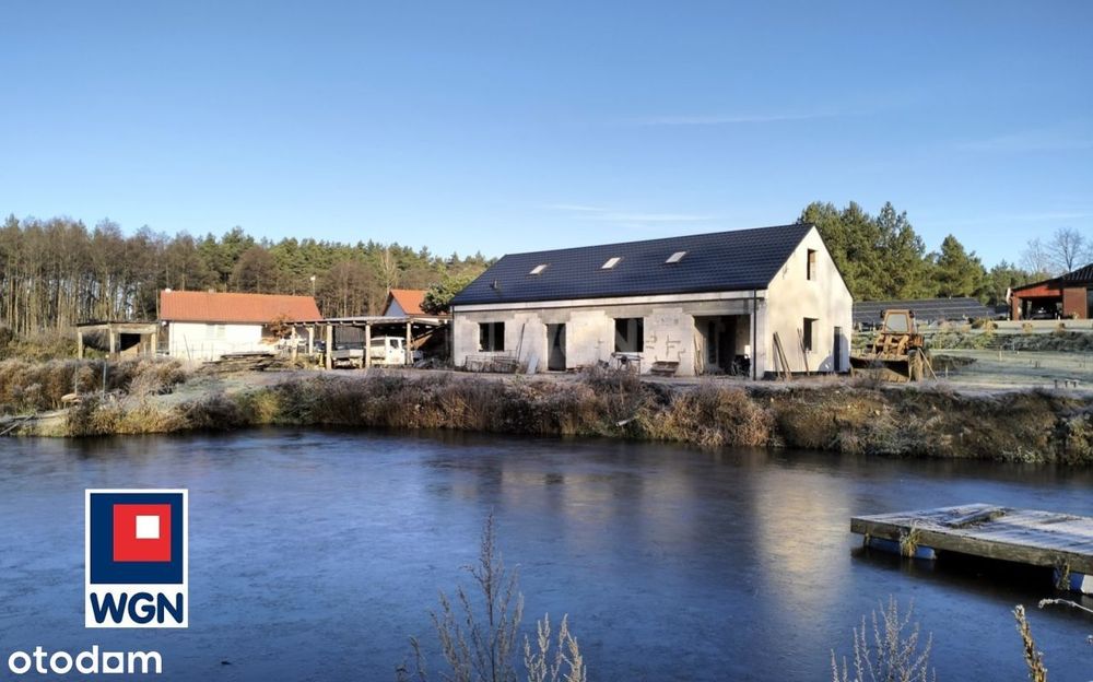 Posiadłość ze stawem z domem w budowie .