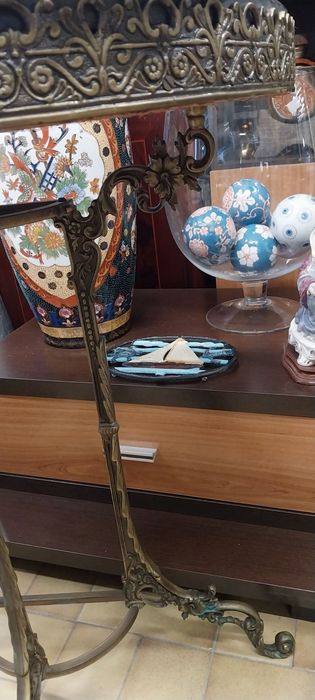 Base para guarda chuvas e espelho de parede com bengaleiro e chapeleiro. Em latão.Mesa meia lua.