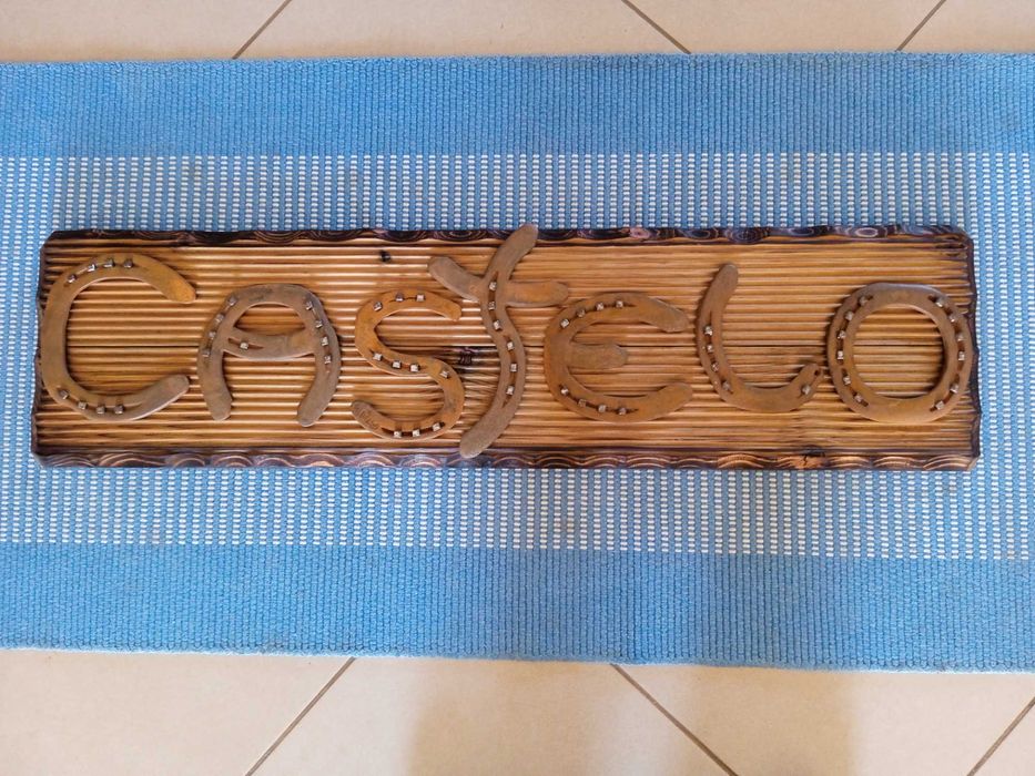 Placa decorativa em madeira de castanho com ferraduras