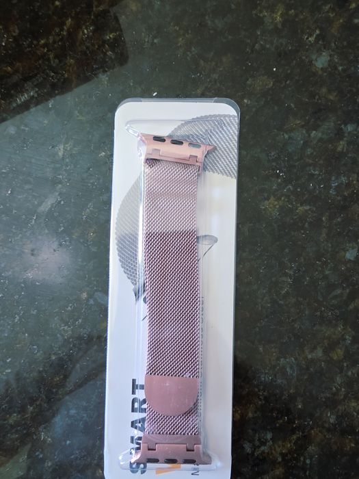 The product shown in the image is a colored Milanese mesh metal bracelet