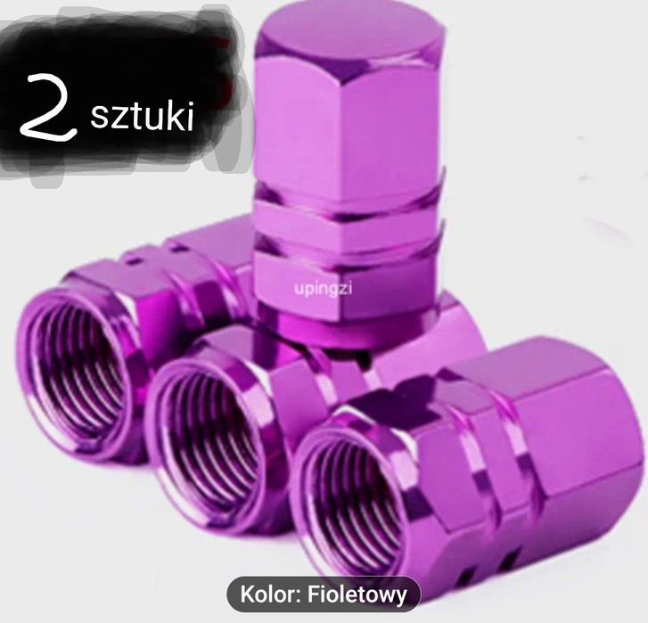 Dwa sześciokątne nakrętki na wentyle wykonane ze stopu aluminium.